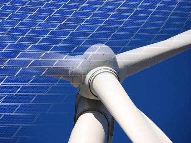 A wind turbine against a clear blue sky.