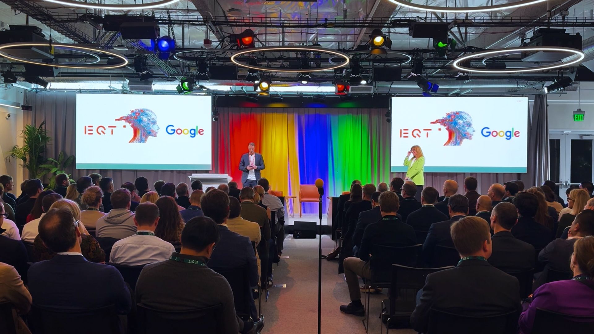 A man presents from a stage