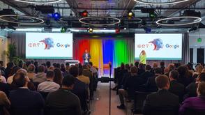 A man presents from a stage