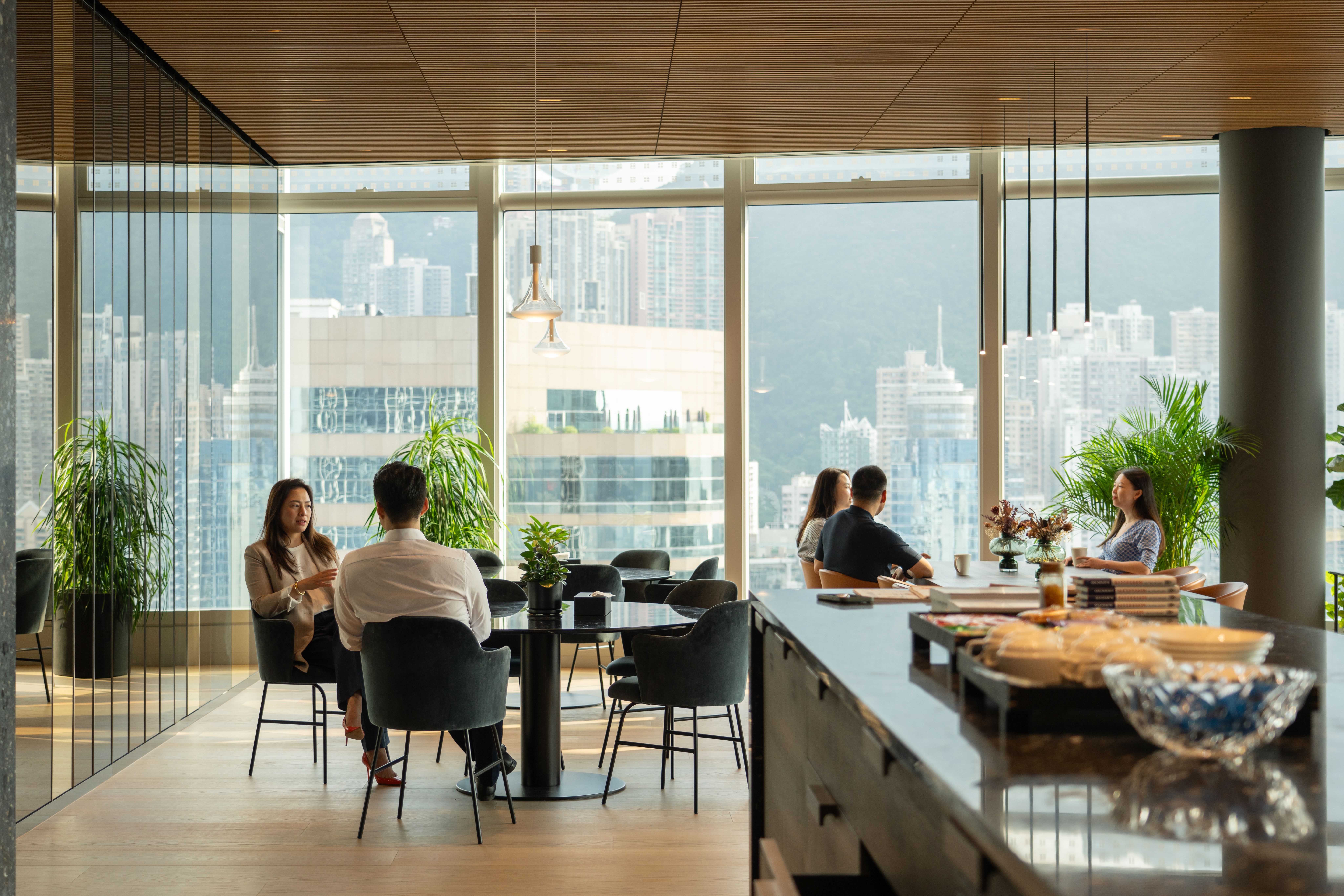 People in Office in front of large window