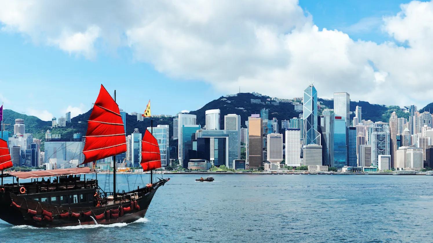 A boat with red sails on the sea in Hong Kong