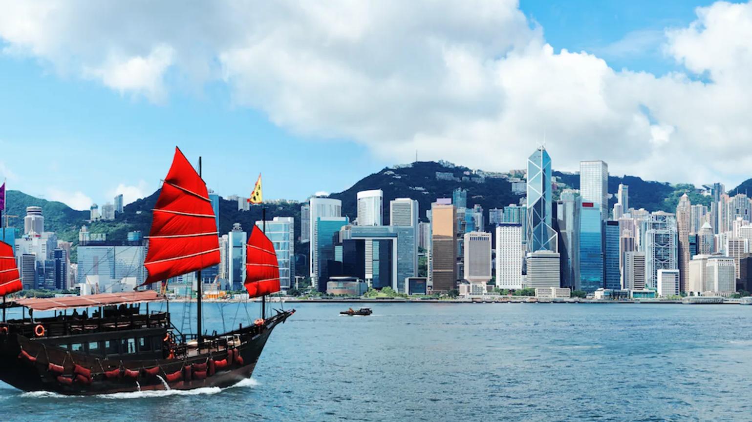 A boat with red sails on the sea in Hong Kong