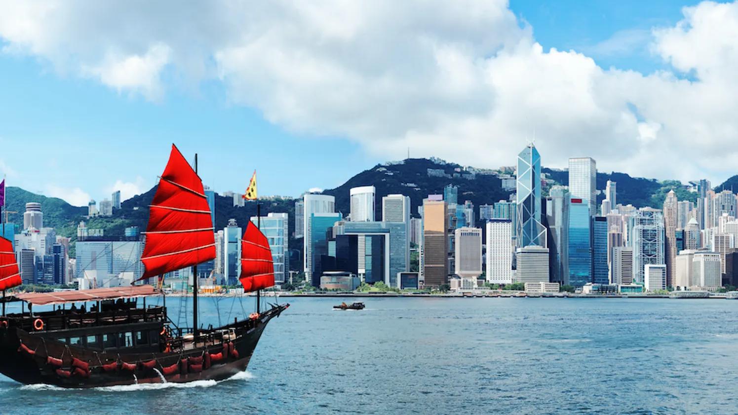 A boat with red sails on the sea in Hong Kong