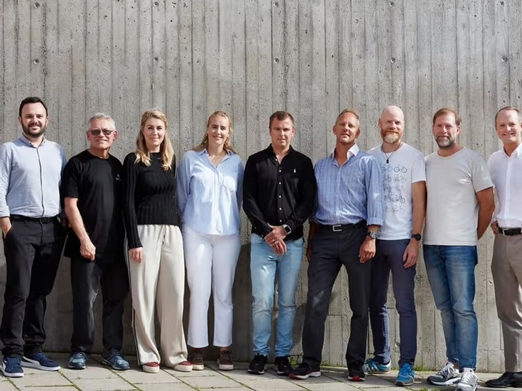 Nine people standing next to each other.