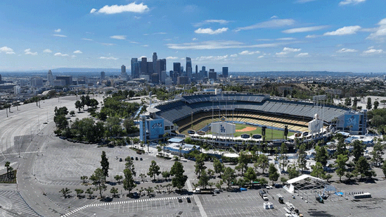 A stadium is seen against the Los Angeles skyline.