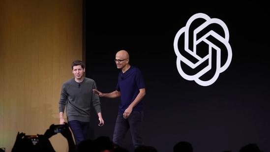 Sam Altman, CEO of OpenAI, and Satya Nadella, CEO of Microsoft, standing side-by-side on a stage in San Francisco.