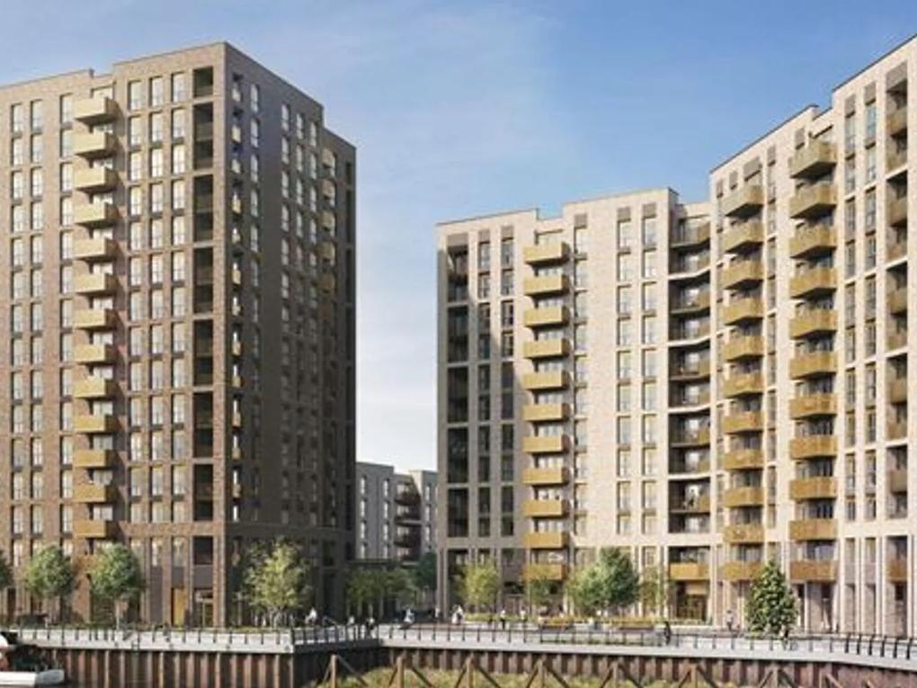 Modern high-rise residential buildings with balconies, surrounded by trees and a pedestrian walkway.
