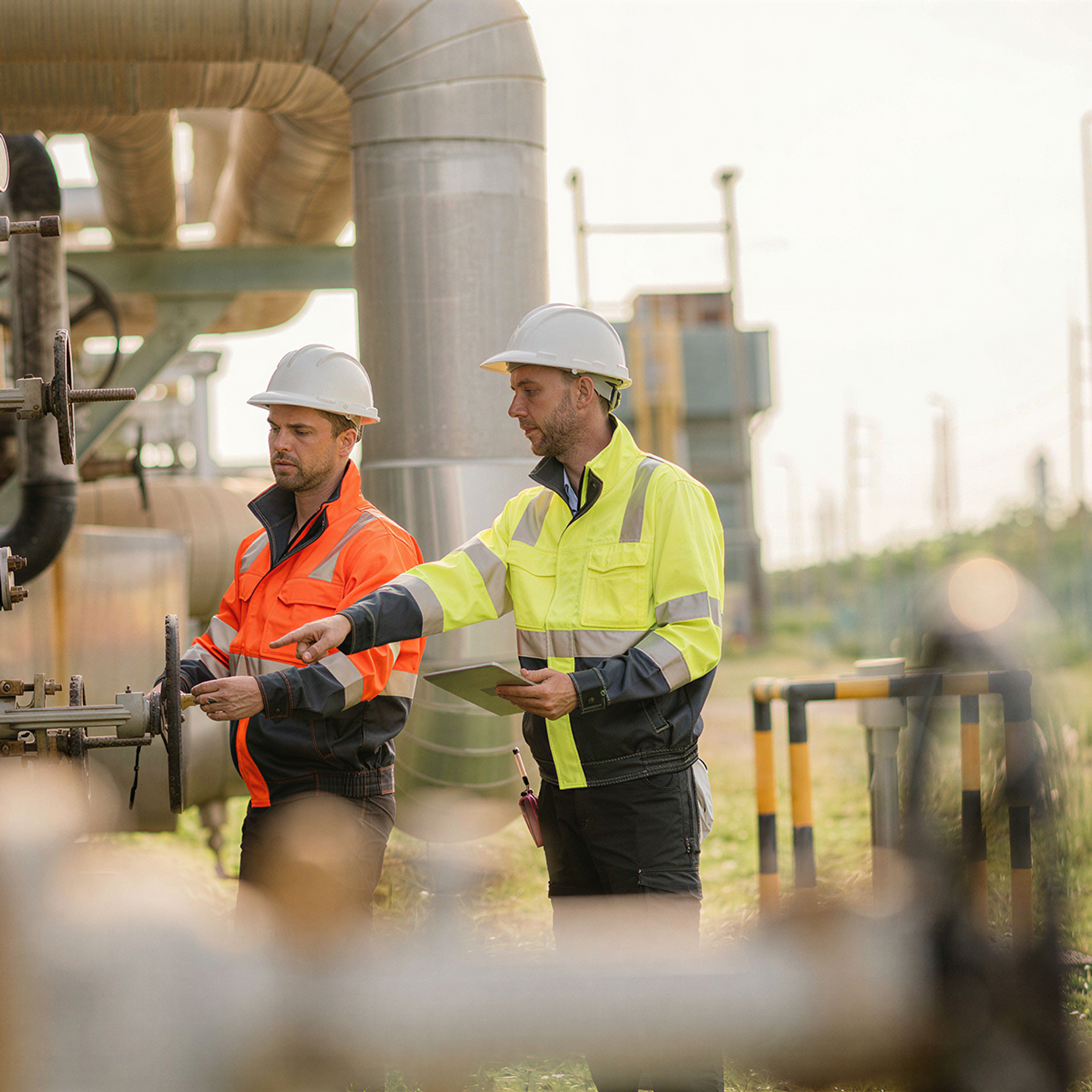Two blue collar workers working on a rig