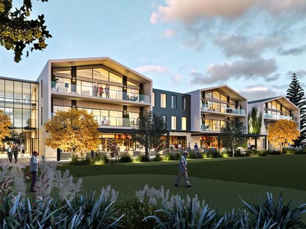 A modern residential building with large glass balconies, surrounded by landscaped gardens and trees.