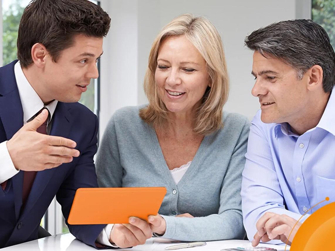 Three people are sitting together, engaged in a discussion.