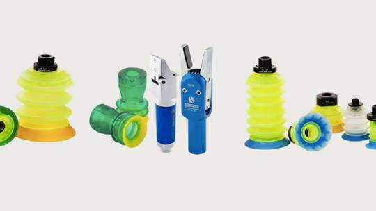 Various industrial suction cups and vacuum components in different colors and sizes displayed on a white background.
