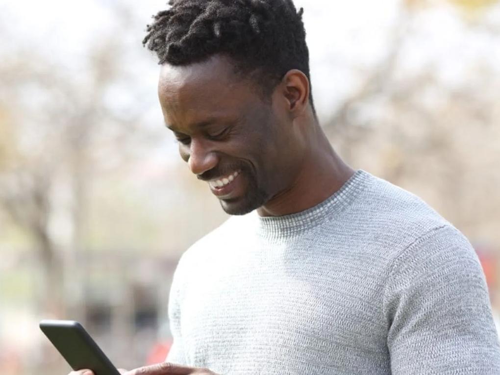 Happy man looking at his phone.