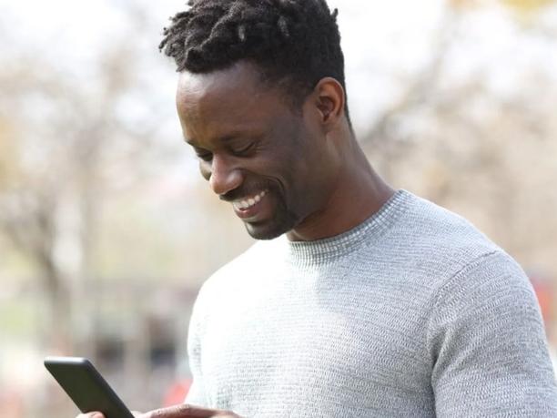 Happy man looking at his phone.