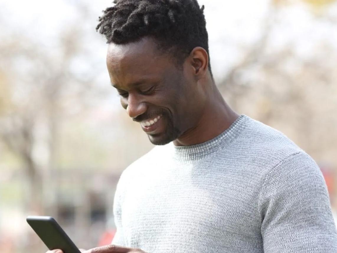 Happy man looking at his phone.