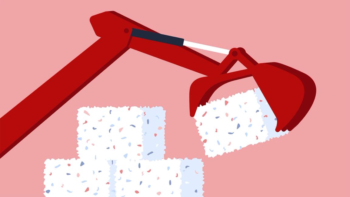 A mechanical arm stacks bales of trash.