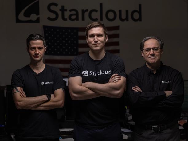 Three men crossing their arms staring right in to the camera with Starcloud merch, infront of an American flag with the Starcloud logo on top.