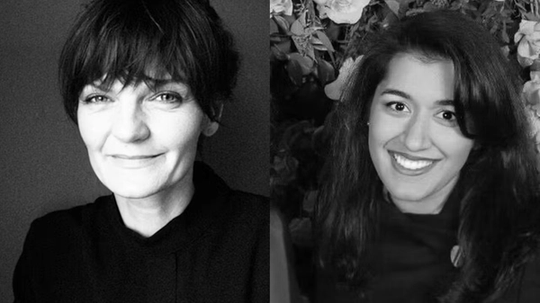 Two women smiling, one with short hair on the left and the other with long hair on the right.