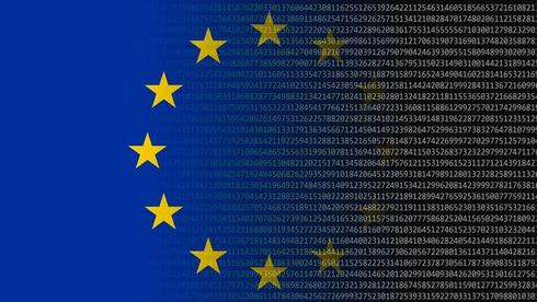 European Union flag with yellow stars mixed with computer text.