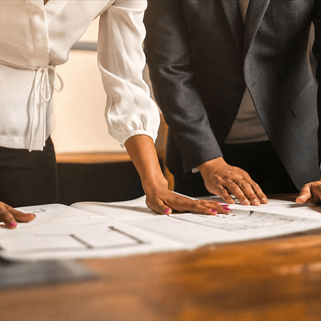 Two people working on paper documents 