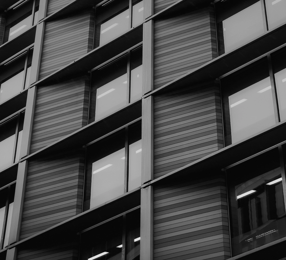 An office building with dark tones focused on the windows