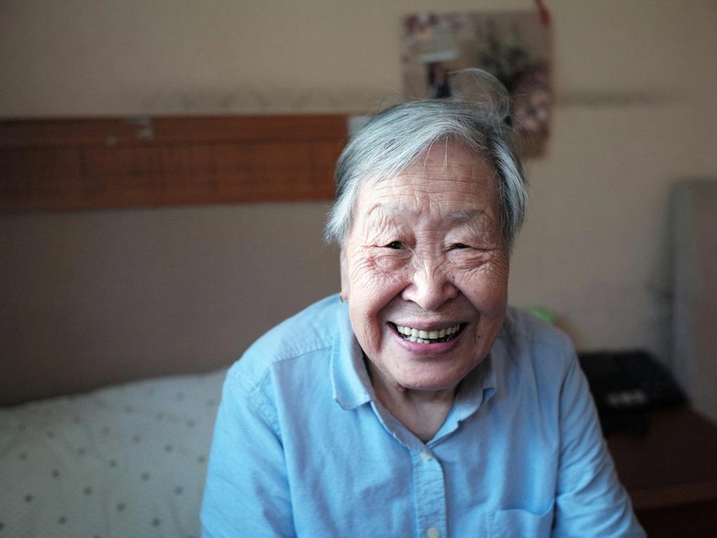 An older person with a happy look on their face.