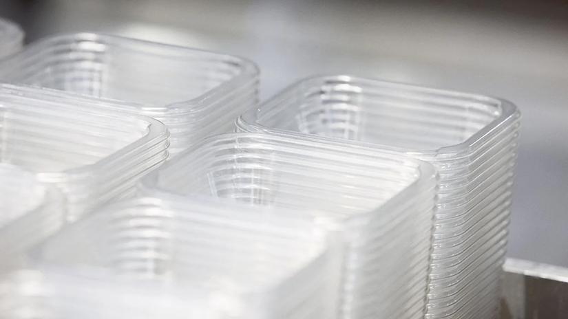 Stacks of clear, rectangular plastic containers arranged neatly, likely used for packaging or storage.
