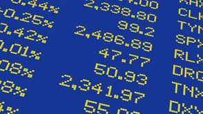 Close-up of digital yellow numbers and percentages on a blue background, resembling a stock market display board.