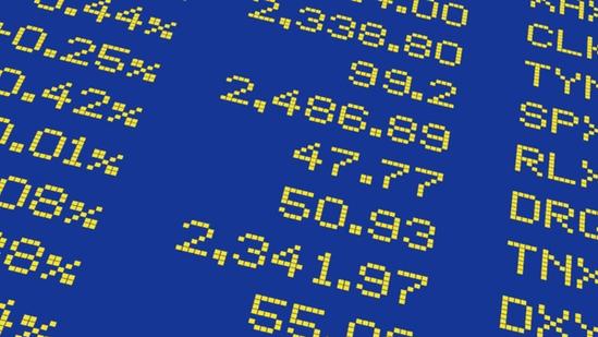Close-up of digital yellow numbers and percentages on a blue background, resembling a stock market display board.