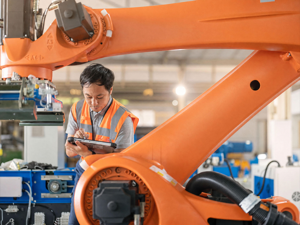 IFS technician calibrating a robot arm.