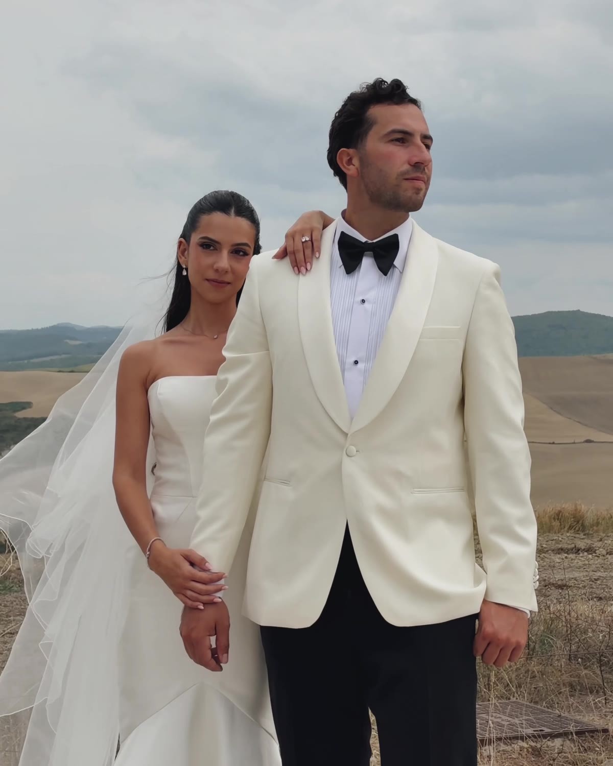 Bride and groom on a cypress-lined road