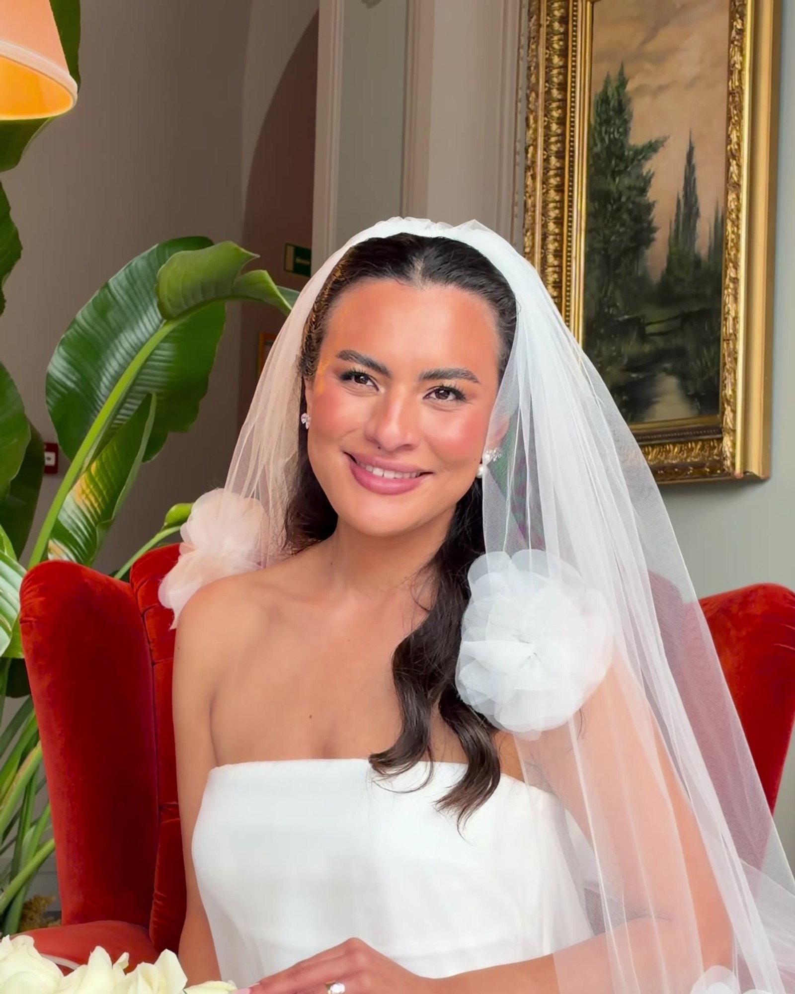Bride smiling in her veil, filmed on a phone