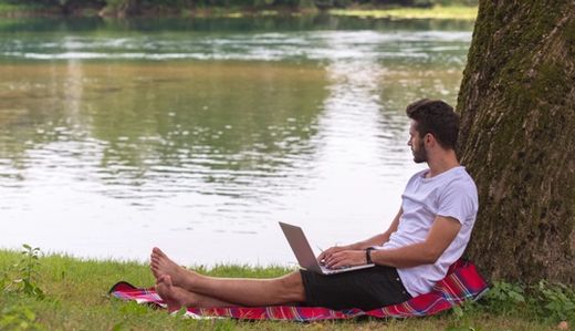 Man with laptop looking away