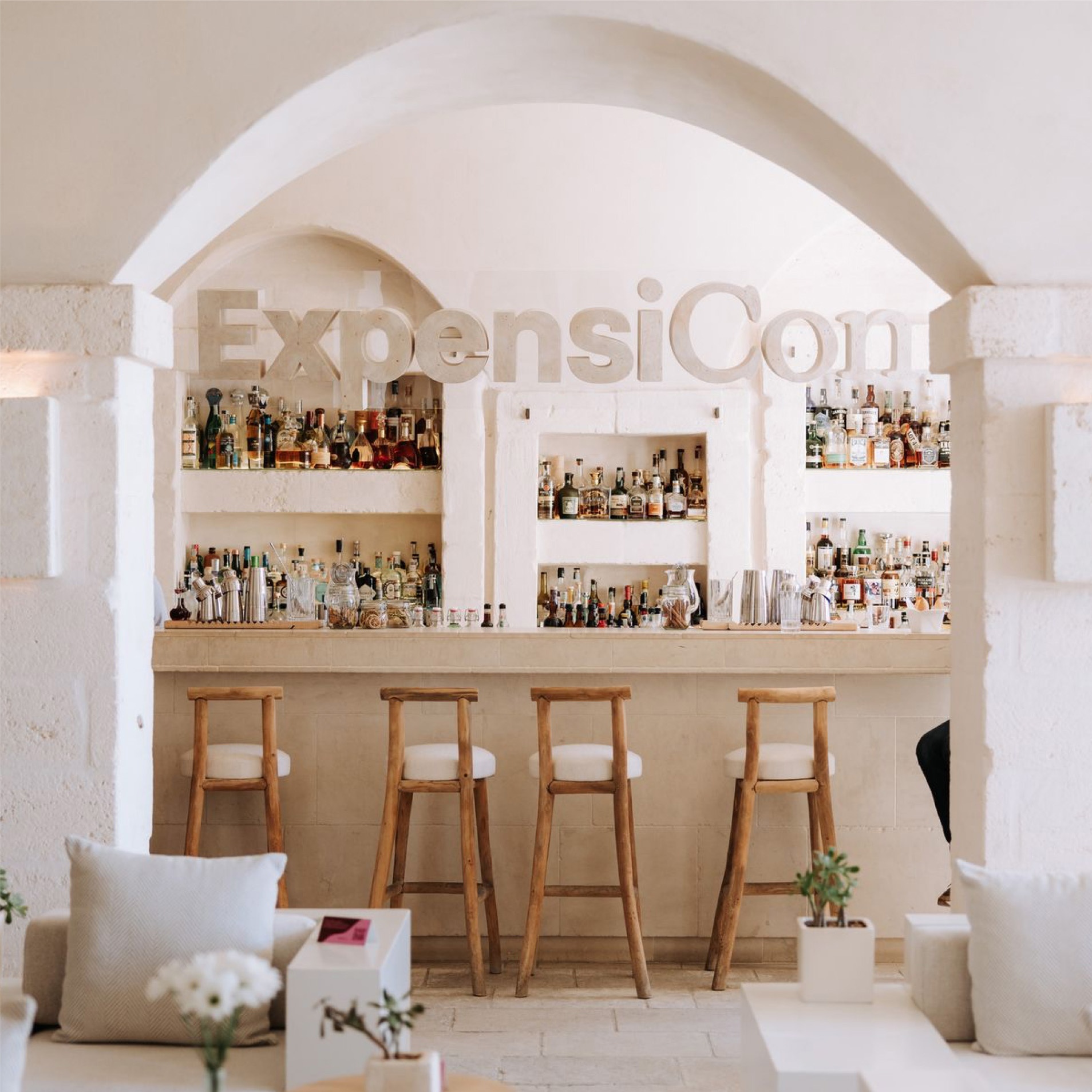 Bar with the Expensicon logo under an arch