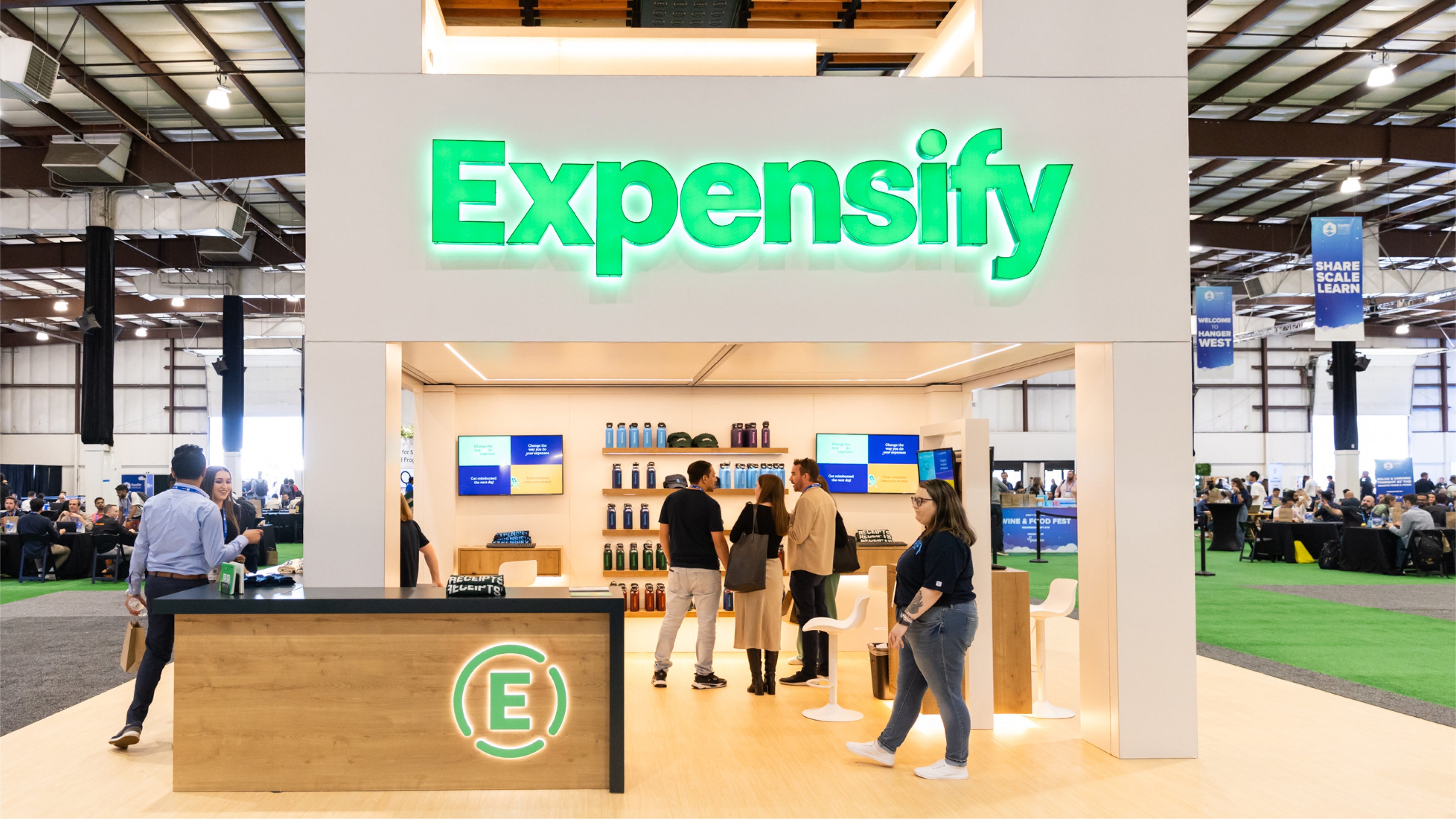 A trade show booth with the word Expensify on it.