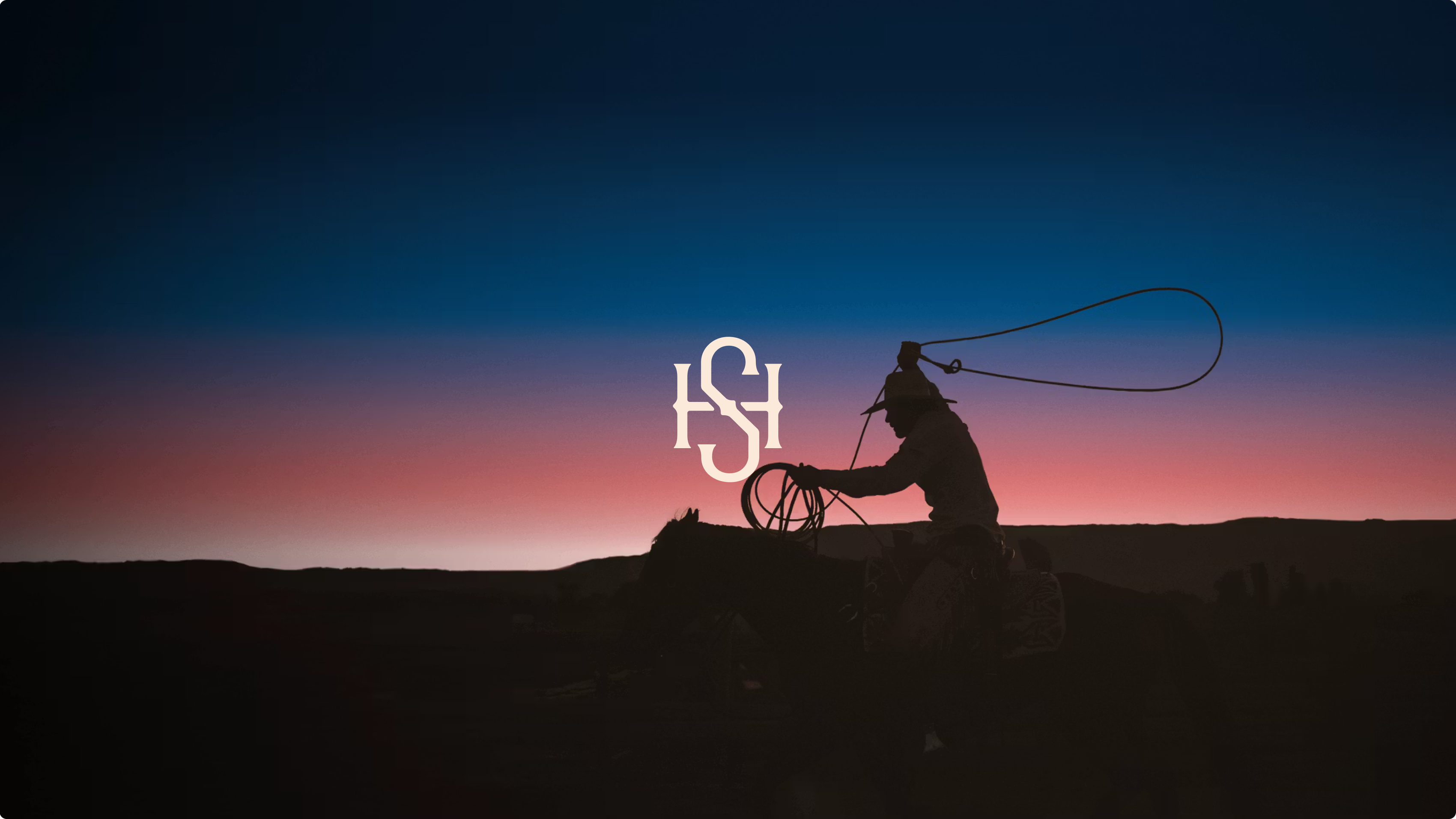 Cowboy with lasso against dramatic sunset