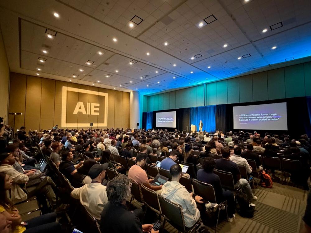 Dennis Pilarinos delivering Unblocked's main-stage talk to a packed room at the AI Engineer World's Fair 2026