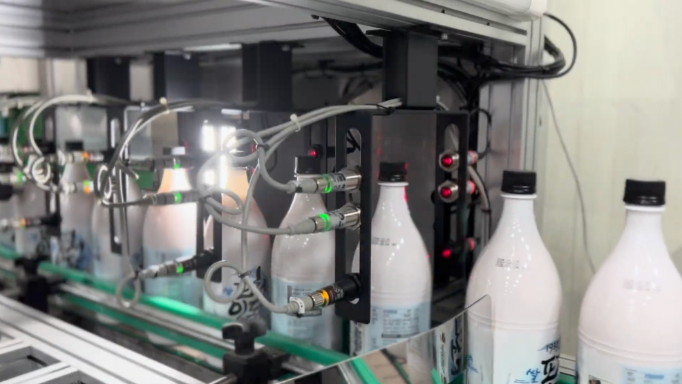 Image of Makgeolli bottles being inspected