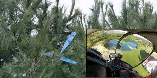 Pescando um avião de controle remoto sobre uma árvore usando um helicóptero