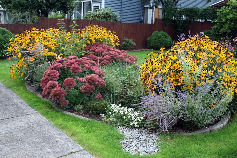 shrubs and plant in a floating garden bed design with pollinator flowers 
