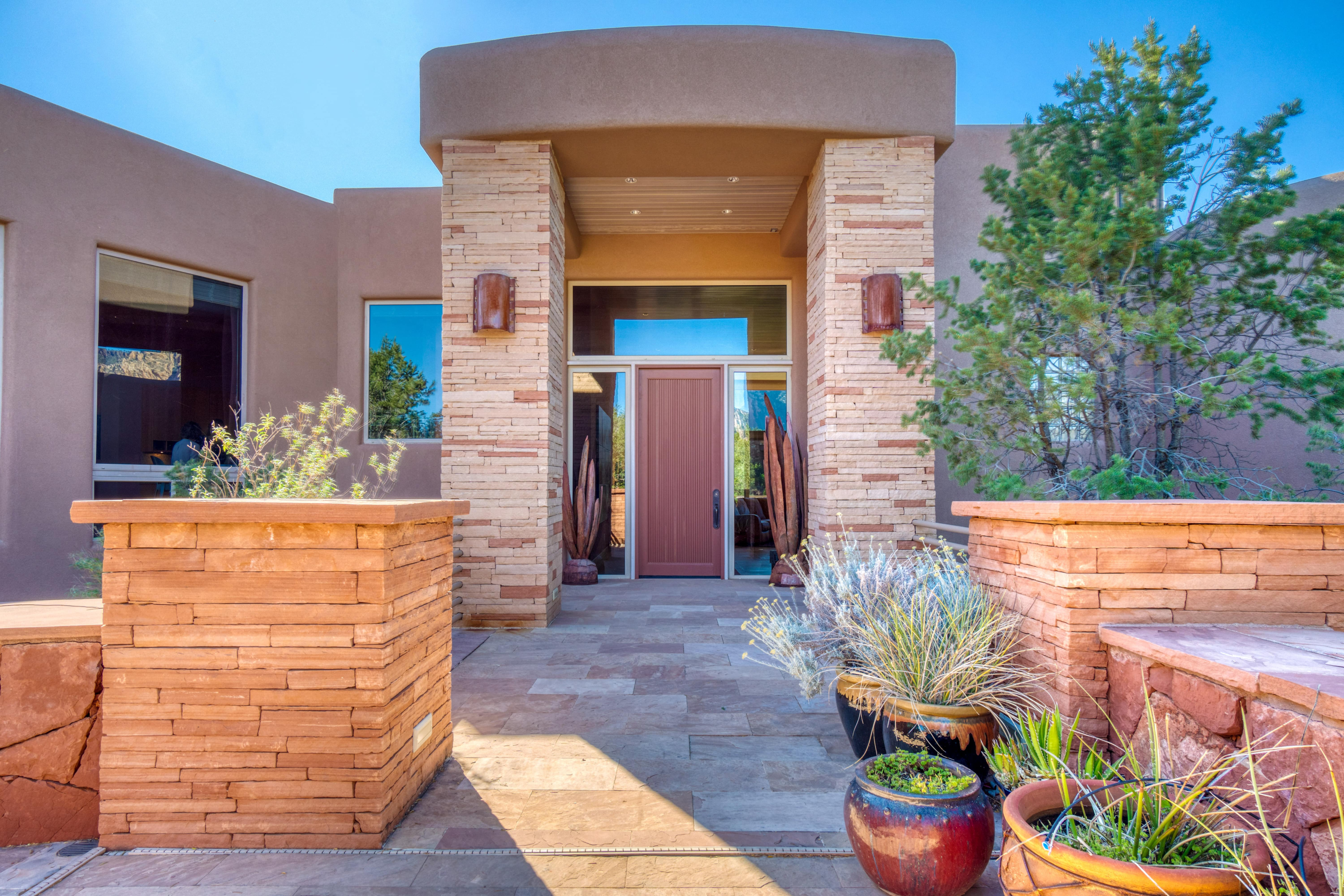 A southwestern entry with a wall that compliments the front of the house and gives it a stately look 