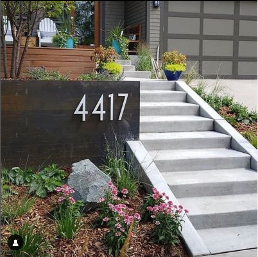 a beautiful front of house with modern house numbers 