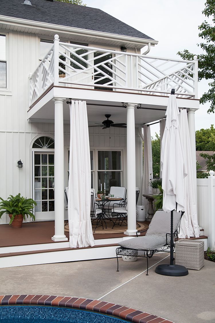 backyard deck ideas next to a plunge pool with a balcony above