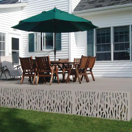 backyard deck ideas a lattice border around the back of a home with an outdoor table and chairs under an umbrella