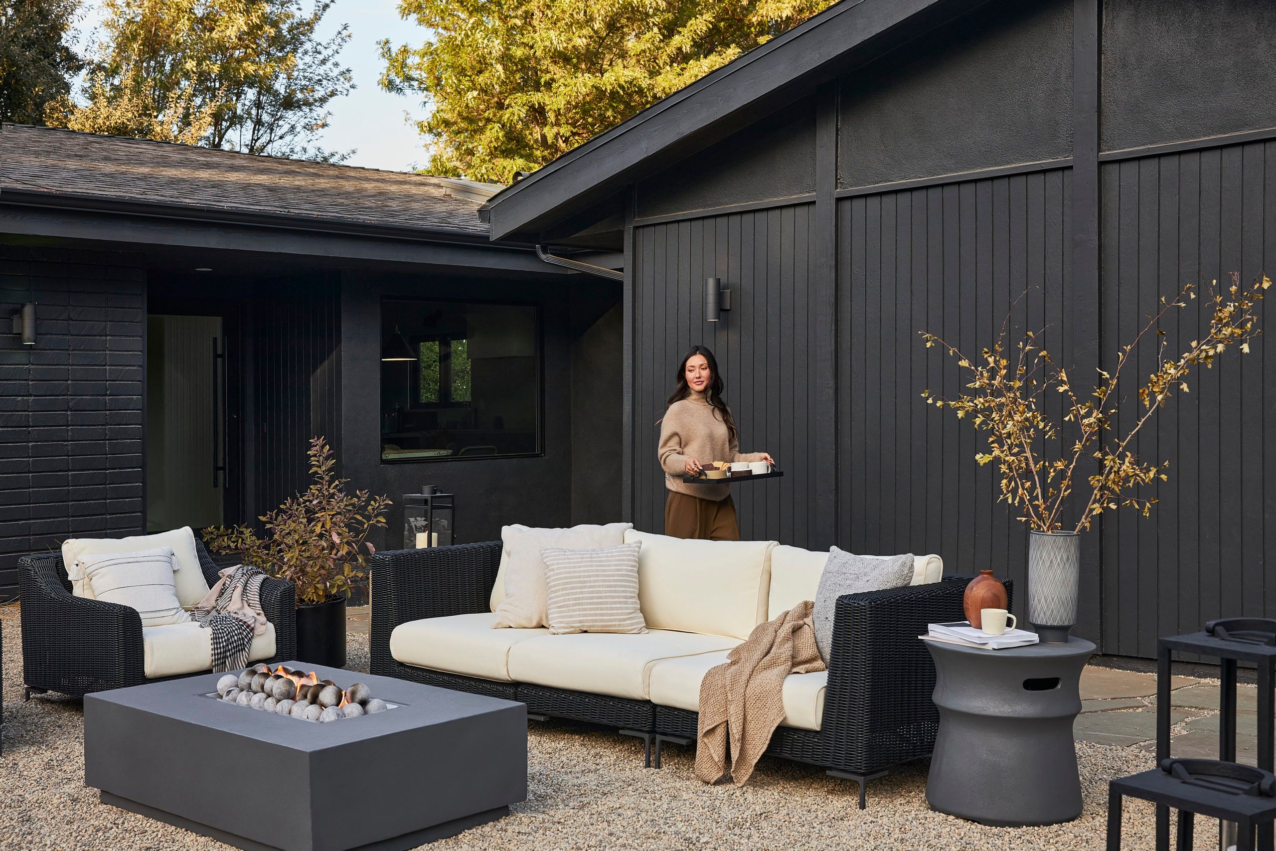 Woman walking behind an outdoor couch