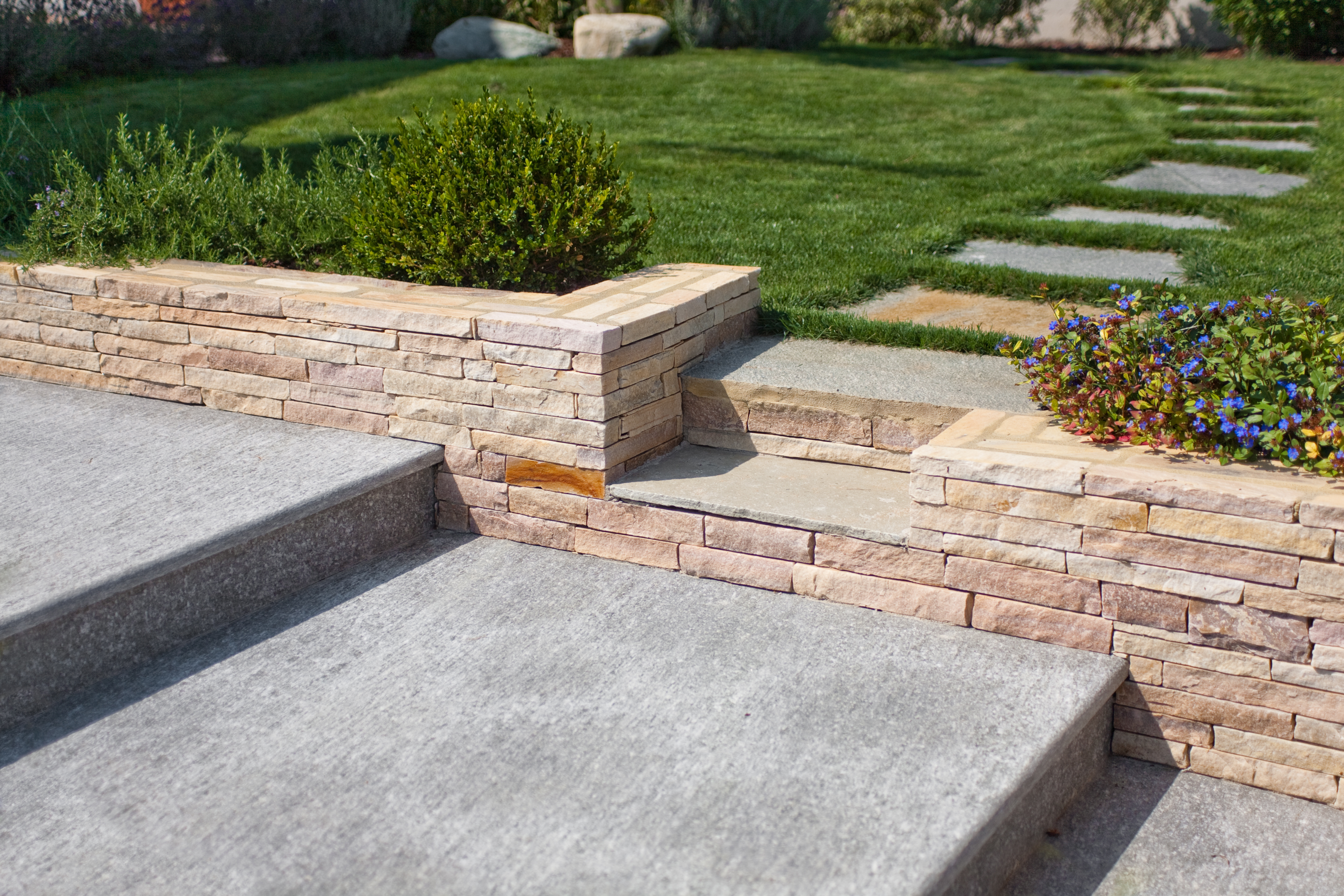 The stone separates the yard from the patio area 