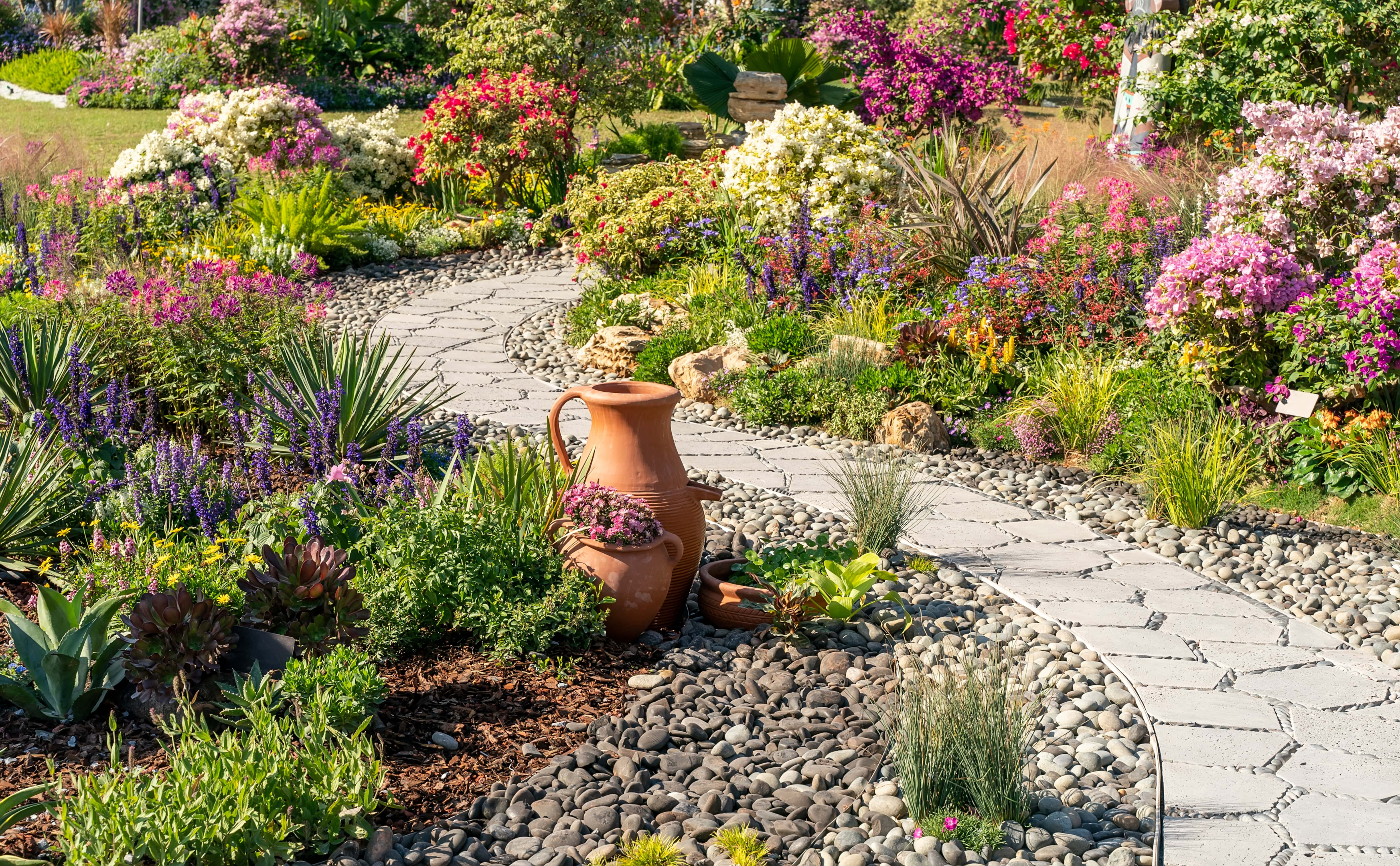 A full colorful garden with a stepping path