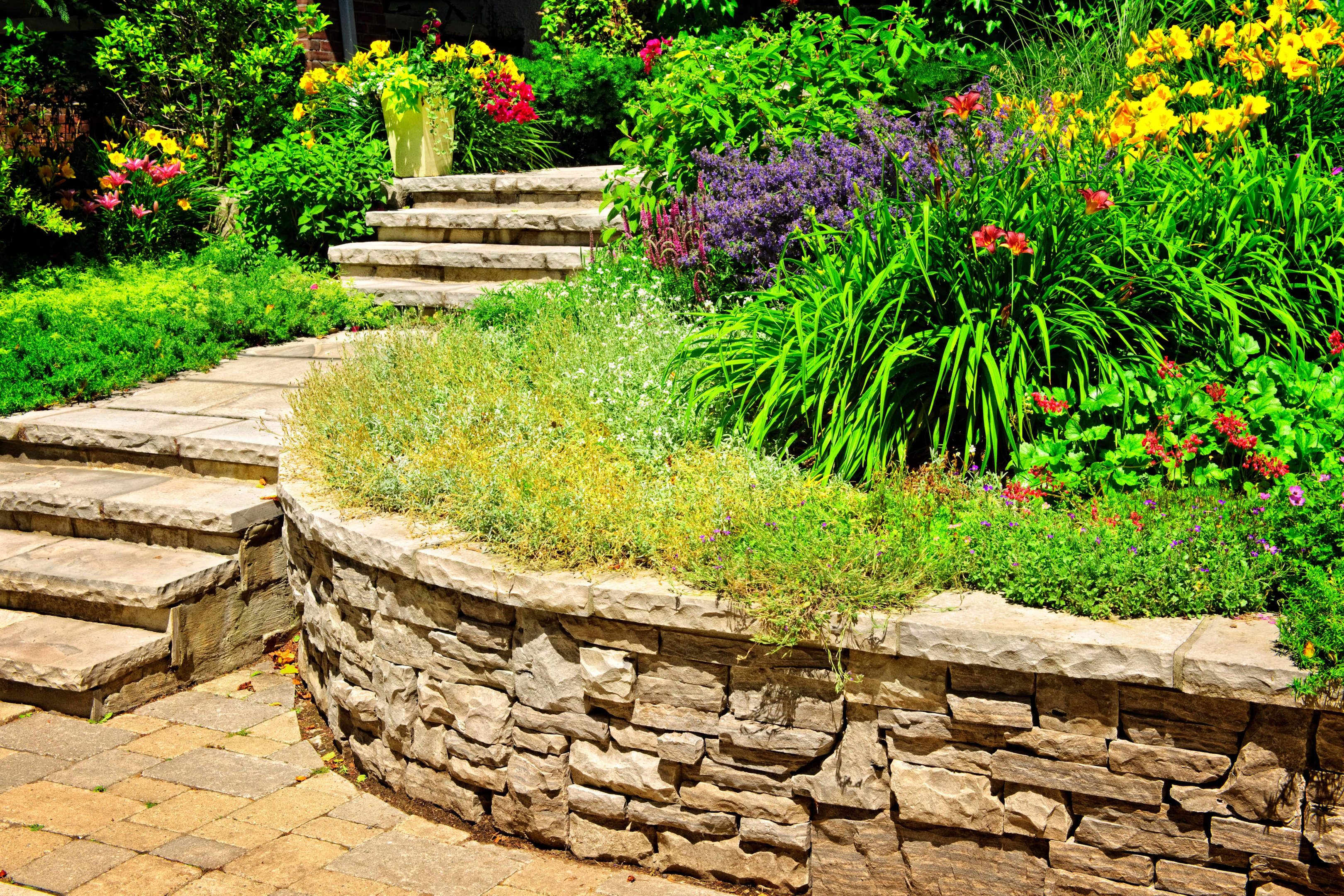 This gorgeous stone wall matches the stairs and provides the perfect frameowrk for a garden