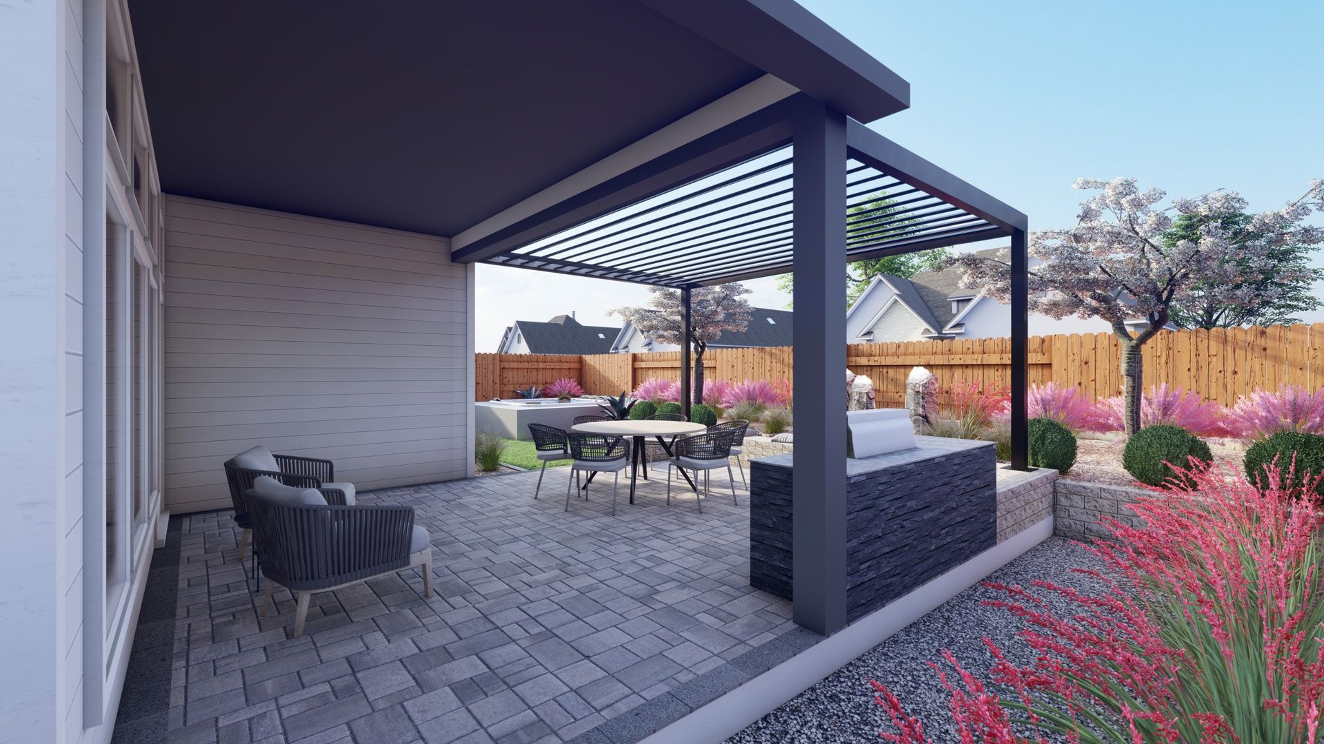a stone patio with a steel pergola overhead and an outdoor grilling area with colorful flowers and trees. A large privacy fence borders the baackyard