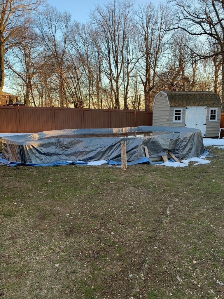 before image of an above ground swimming pool in an outdoor living space with no landscaping or pool walls