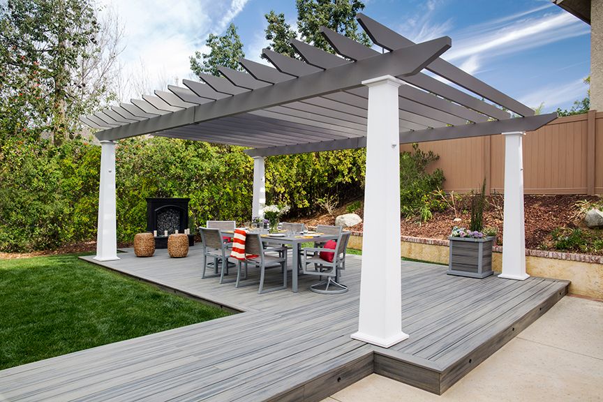 backyard deck ideas with a pergola over it and an outdoor dining table below